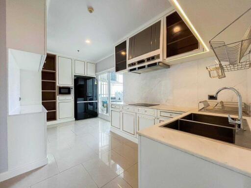 Modern kitchen with white cabinets and built-in appliances