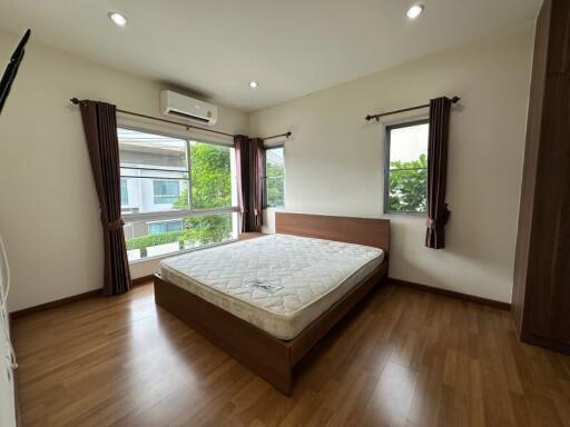 Spacious bedroom with large windows and a double bed