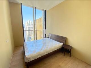 Modern bedroom with large window and city view