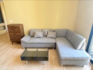 Cozy living room area with a grey sectional sofa