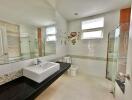 Modern bathroom with large mirror and glass shower enclosure