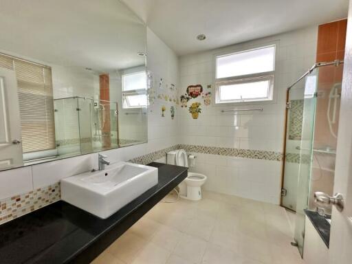 Modern bathroom with large mirror and glass shower enclosure