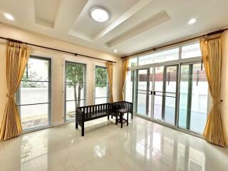 Bright living room with large windows and seating bench