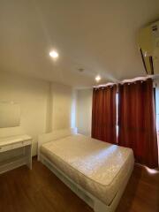 Bedroom with bed, curtains, and side table