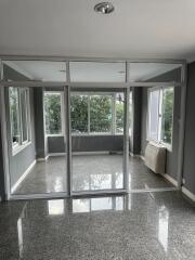 Living area with glass partition and large windows