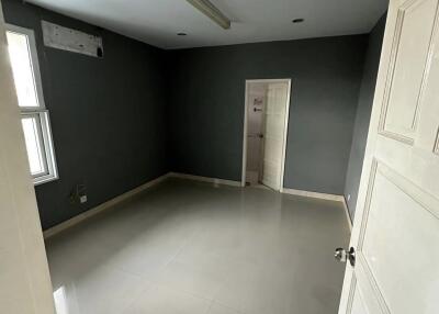Empty room with grey walls and white tiled floor