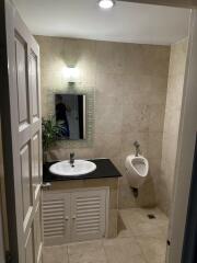 Modern bathroom with sink, mirror, and urinal