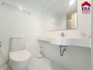 Modern bathroom with large mirror and clean fixtures