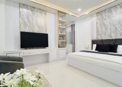 Modern Bedroom with Built-in Shelving and TV