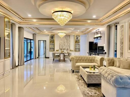 Elegant and spacious living room with chandeliers and modern decor