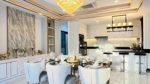 Modern kitchen and dining area with chandelier