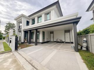 Exterior view of a modern two-story house with a driveway and garage