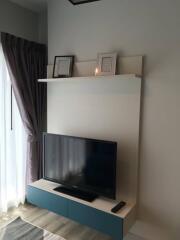 Living room with wall-mounted TV and console