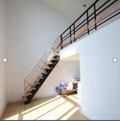 Bright living area with loft and modern staircase