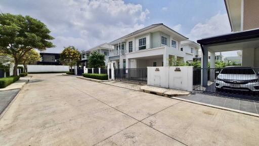 Front view of a residential building with a driveway and carport