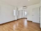 Spacious living room with wooden flooring and air conditioning