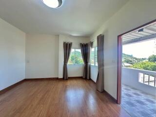 Spacious bedroom with large windows and connected balcony