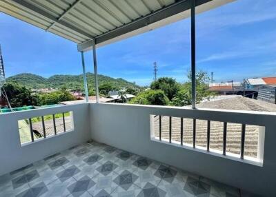 Spacious balcony with scenic mountain view and tiled floor