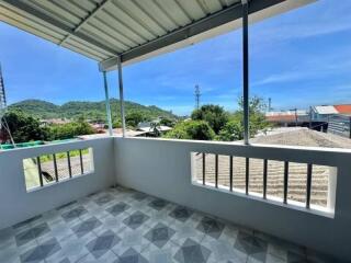 Spacious balcony with scenic mountain view and tiled floor