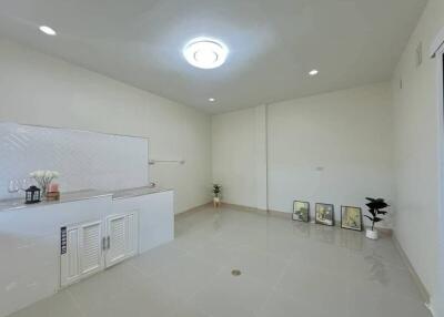 Modern minimalist main living area with white walls and tiled flooring