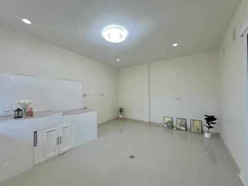 Modern minimalist main living area with white walls and tiled flooring