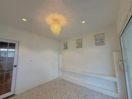 Minimalist room with chandelier and glass door
