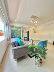 Modern living room with large window and contemporary furnishings