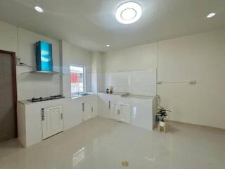 Modern kitchen with white cabinets and appliances