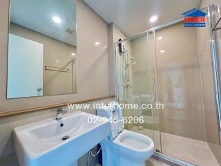 Modern bathroom with glass-enclosed shower