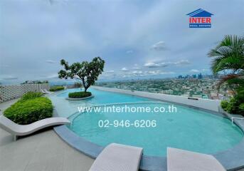 Rooftop infinity pool with lounge chairs and city skyline view