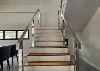 Modern staircase with glass railing in a bright room