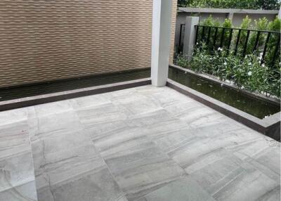 patio with tiled floor and partial view of garden