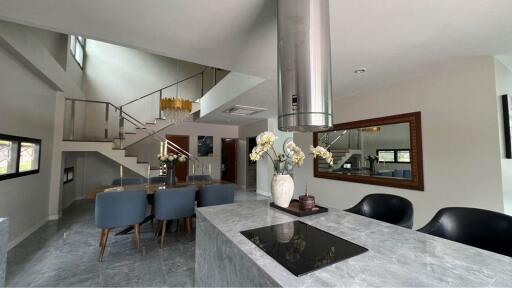 Modern kitchen with dining area and staircase