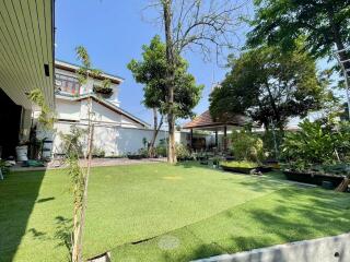 Spacious yard with trees and a gazebo