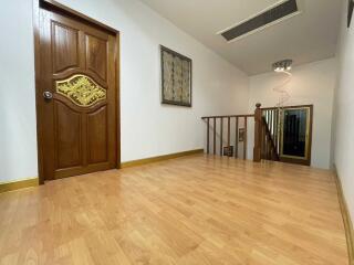 Spacious upstairs hallway with wooden flooring