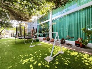 Spacious backyard with swing and trampoline