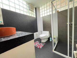 Modern bathroom with glass shower and black accents