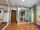 Bedroom with wooden floor, mirrored closet, and large window