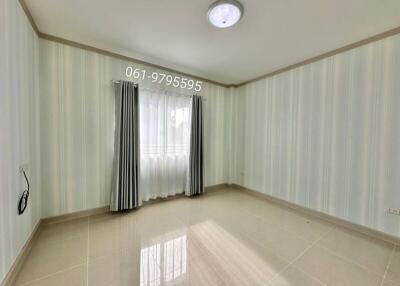 Empty room with tiled floor and window with curtains