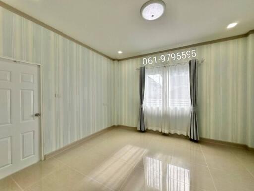 Empty bedroom with tiled floor and striped wallpaper