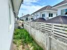 Backyard view with neighboring houses and greenery