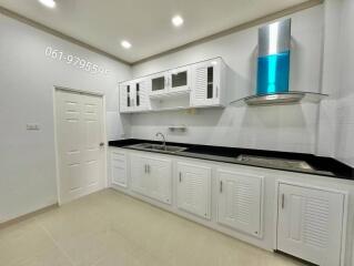 Modern kitchen with white cabinets and stainless steel range hood