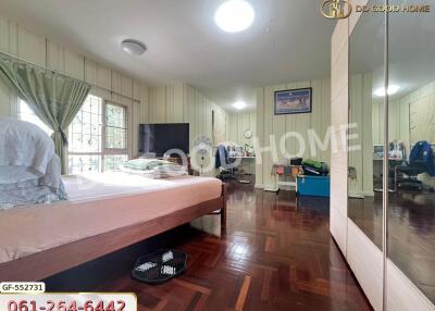 Spacious bedroom with wooden flooring and modern amenities