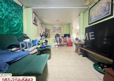 Spacious living room with TV, sofa, and a desk area