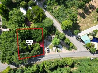 Aerial view of a land plot surrounded by greenery