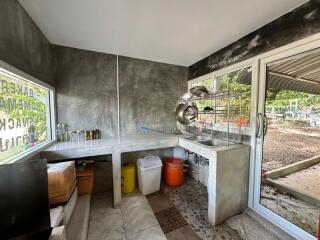 Modern kitchen with concrete countertops and large windows