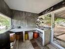 Modern kitchen with concrete countertops and large windows