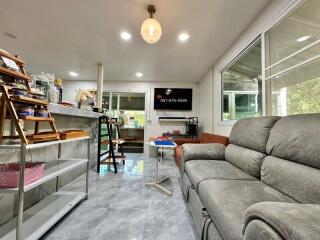 Modern living room with grey couch and wall-mounted TV