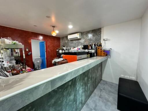 Modern kitchen with marble countertop and bar seating