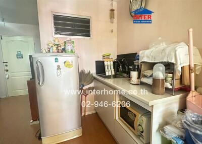 Small kitchen area with appliances and decor